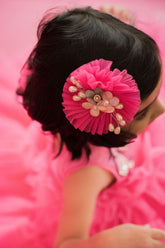 Bright pink circular hair accessory